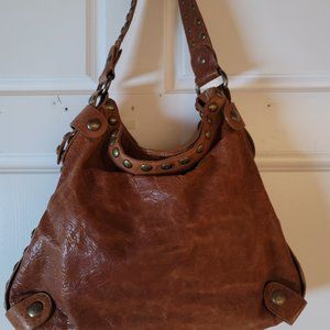 Kooba thick bourbon colored leather tote bag with metal grommets